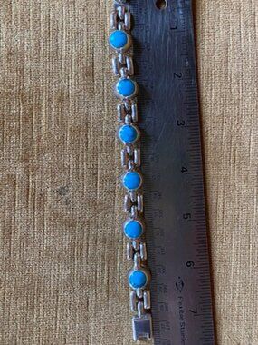 Sterling silver link bracelet with round blue turquoise stones in a Navajo style